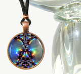 Handmade round necklace with abstract art print sealed under glass in a rainbow pattern, artwork by Primal Painter