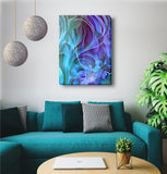 Swirling abstract camvas art in purples, blues, and teal with vague impressions of flowers and foliage hanging above a blue couch