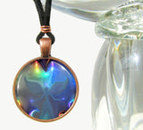 round necklace featuring pastel angel art print in teals and rainbow highlights, sealed under glass