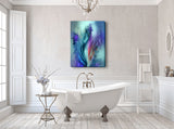 Abstract flower canvas art in blues, purples, and teals with a smoky ethereal quality hanging in a white bathroom