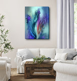 Abstract flower canvas art in blues, purples, and teals with a smoky ethereal quality hanging in a white living room