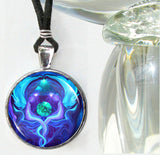 Handmade round necklace featuring Reiki energy art by Primal Painter with two blue angels meditating, healing, and protecting the earth between them and sealed under a glass dome