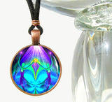 round necklace featuring purp.e and teal twin flame angel art by Primal Painter of twin flames hand in hand under a purple ray and healing a broken heart, sealed under glass
