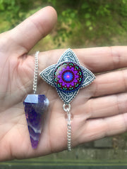 amethyst crystal pendulum with a silver pendant featuring purple and green mandala art by Primal Painter