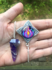 amethyst crystal pendulum featuring a silver pendant containing violet flame artwork by Primal Painter