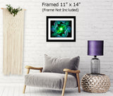 Abstract art in green with two angels facing a central green starburst and surrounded by abstract patterns and displayed in a frame hanging over a chair