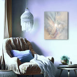 Subtle peach, gray, and plum abstract art canvas print called The Angelic Realm by Primal Painter, hanging over a cozy chair