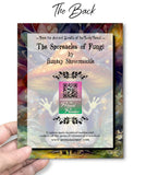 The back of a greeting card that says 'The Sporeacles of Fungi' by Auntsy Shroomsickle and held by a hand with a colorful abstract design in the background.