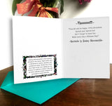 Greeting card with text and decorative elements on a wooden surface