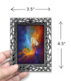 Mini goddess art called Nebula by Primal Painter and displayed in a pewter frame. In a hand with dimensions