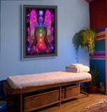 colorful chakra art print with a fuchsia angel torso with the seven chakra colors aligned down the center, and blue lights in her hands and a Reiki symbol over her head, framed over a massage table