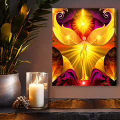A vibrant, stretched canvas print called The Becoming by Primal Painter featuring a sleek yellow chakra angel with light rays, set against a fuchsia and orange  textured background. Hanging above a shelf with candles