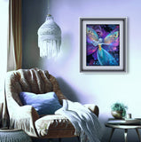 Framed artwork of a fairy with butterfly wings in a cozy living room.