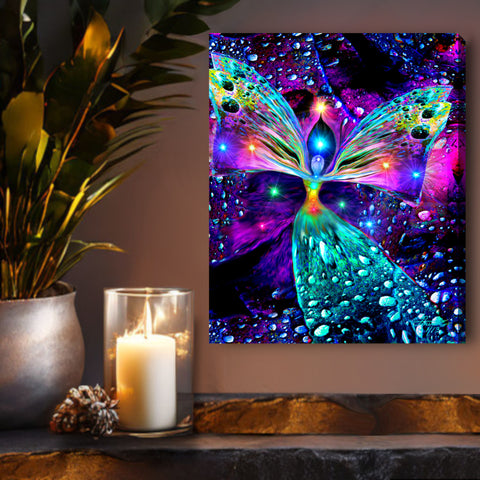 A stretched canvas print called Bubbles of Clearing by Primal Painter featuring a colorful, abstract chakra angel design with a background of multicolored bubbles. Framed above a shelf with candles