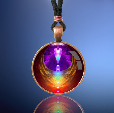 handmade round necklace with reiki-inspired art by Primal Painter featuring the seven chakras in a vertical line inside angel angel wings with a heart above and sealed under a glass dome