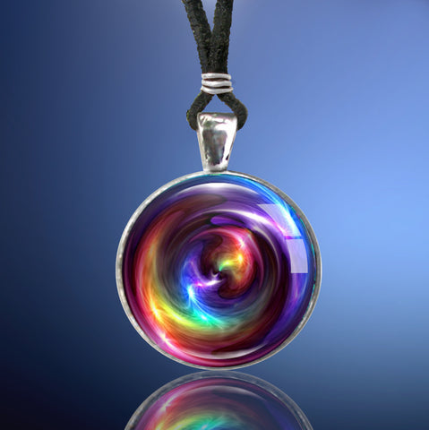 Handmade round necklace featuring original arty by Primal Painter with rainbow chakra colors in a swirling pattern and sealed under a glass dome
