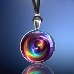 Handmade round necklace featuring original art by Primal Painter with rainbow chakra colors in a swirling pattern and sealed under a glass dome