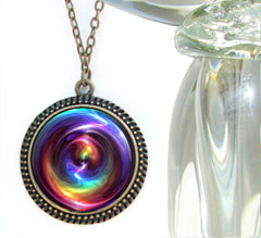 rainbow chakra swirl art in a large bronze necklace setting and set under a glass dome. Art By Primal Painter
