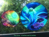 Two colorful fairy-themed circular suncatchers with floral designs against a natural background.