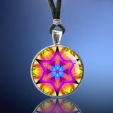 Star mandala art necklace in bright colors in a round silver setting. 