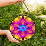Textured glass suncatcher featuring a mandala with six points representing Connections in vibrant pink, yellow and blue colors 