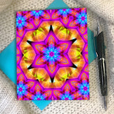 Colorful star shaped mandala artwork as a greeting card with a blue envelope
