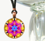 Star mandala art necklace in bright colors in a round copper setting. 