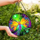Textured round glass suncatcher featuring rainbow fairy artwork by Primal Painter. 
