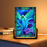 Glowing acrylic light featuring a blue and teal fairy with purple flowers and stained glass-like flower border. Art by Primal Painter. 