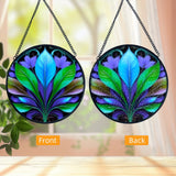 Front and back views. Textured glass suncatcher of a blue, green, and purple botanical leaf design. 
