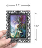 Framed pastel fairy in a garden artwork with art nouveau designs, held by a hand with dimensions.