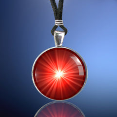 Handmade first chakra necklace featuring a bright starburst art print sealed under glass and representing the root chakra