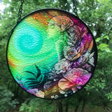 Back view of a Colorful round glass suncatcher featuring Flower Child by Primal Painter. Rainbow colors and flowers. 