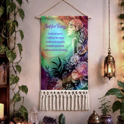 A bohemian-style wall tapestry hanging on a beige wall, decorated with a colorful illustration of Flower Child by Primal Painter, surrounded by flowers and The Reiki Principles The tapestry features a wooden hanging rod, a natural twine hanger, and a white macrame fringe at the bottom.