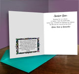 Greeting card with text and decorative border on a wooden surface