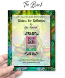 The back of a colorful greeting card with a frog wearing glasses in a meditative pose, illustrated by Primal Painter.