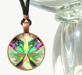 Handmade necklace featuring a metaphysical art print sealed under a glass dome of a pastel green, yellow, and pink angel with flowing patterns