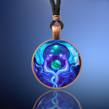 Handmade round necklace featuring Reiki energy art by Primal Painter with twin flame blue angels meditating, healing, and protecting the earth between them and sealed under a glass dome