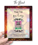 The back  of a Colorful greeting card with an illustration of a grumpy raccoon with his tail on fire and holding a wand shooting fireballs, created by Primal Painter