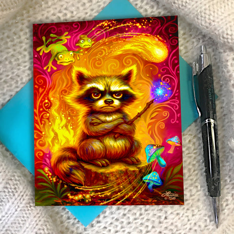 Colorful greeting card with an illustration of a grumpy raccoon with his tail on fire and holding a wand shooting fireballs, created by Primal Painter