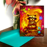 Colorful greeting card with an illustration of a grumpy raccoon with his tail on fire and holding a wand shooting fireballs, created by Primal Painter