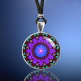 Intuition mandala necklace in a round silver setting. Purple and blue theme.