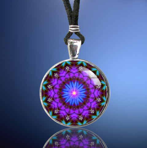 purple mandala wearable art pendant necklace in a silver setting against a blue background and features a blue starburst center