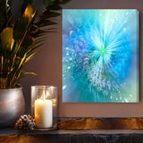 Swirling abstract art canvas print with sparkles in pastel blues, greens, and a touch of lavender called "Intuitive Sparks" by Primal Painter. Displayed above a shelf with a candle