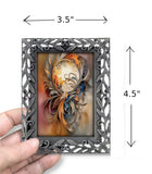 Mini goddess art print called The Keeper by Primal Painter and includes a decorative pewter frame.  Held in a hand with dimensions