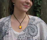 Bright orange Light Being necklace on a model