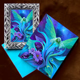 Framed mini print and matching greeting card gift set of an ethereal blue fairy emerging from purple flowers by Primal Painter