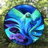 Round glass fairy suncatcher in a black frame and a hanging black chain featuring Lunaria Silvermist of the Fae Realm by Primal Painter. Blues, greens, and purples, and florals. 