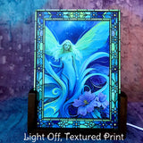 Acrylic light with the light turned off featuring a blue and teal fairy with purple flowers and stained glass-like flower border. Art by Primal Painter. 