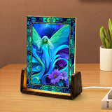 Glowing acrylic light featuring a blue and teal fairy with purple flowers and stained glass-like flower border. Art by Primal Painter. 